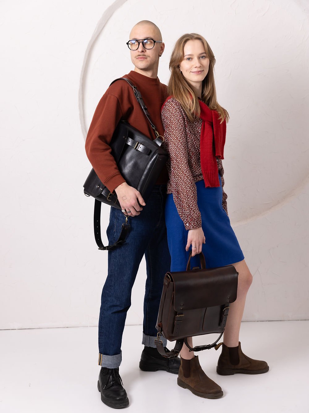 7. Male model wearing TOKS VISOKS BENJAMIN Backpack in dark chocolate leather, side view in studio