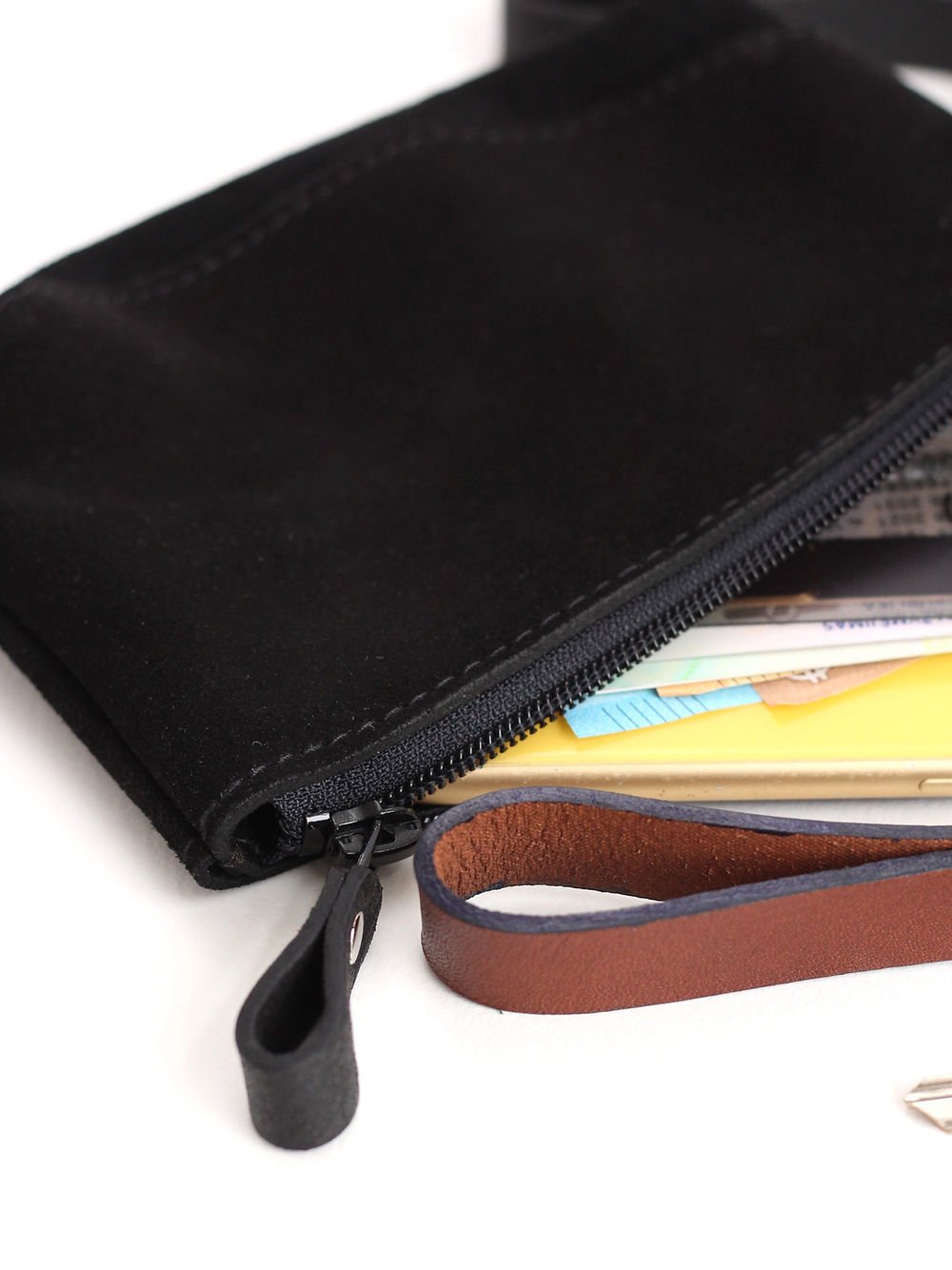 1. Close-up of TOKS VISOKS black suede POUCH Wallet with zipper closure, showing cards and wrist strap