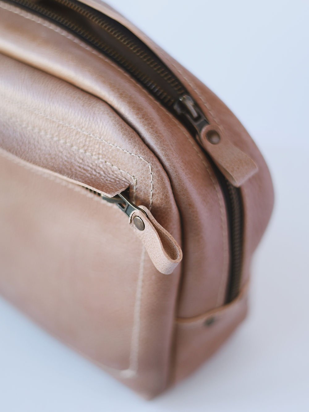 6. Close-up of zipper and stitching on beige DOUGLAS Toiletry Bag by TOKS VISOKS, emphasizing quality