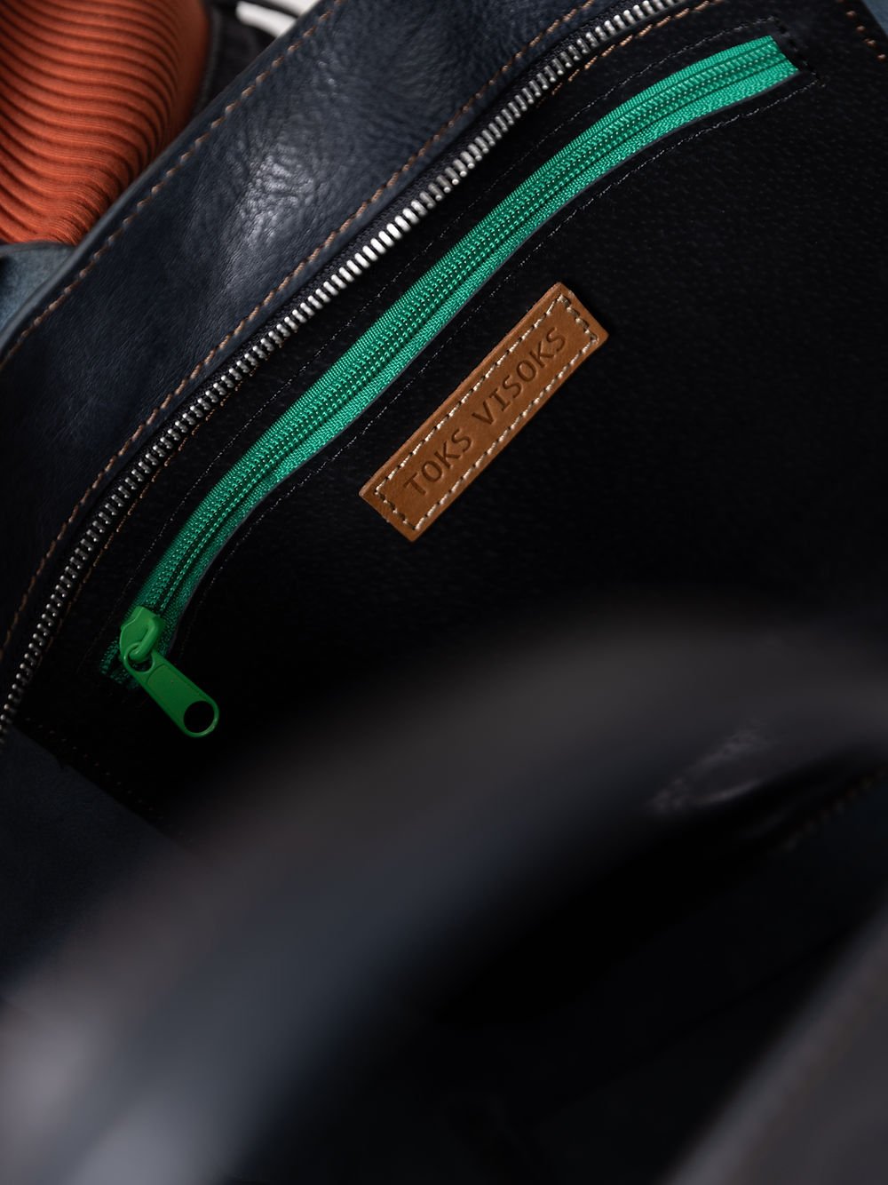 6. Close-up of MIGLE Leather Handbag interior, showing TOKS VISOKS branding and green zipper