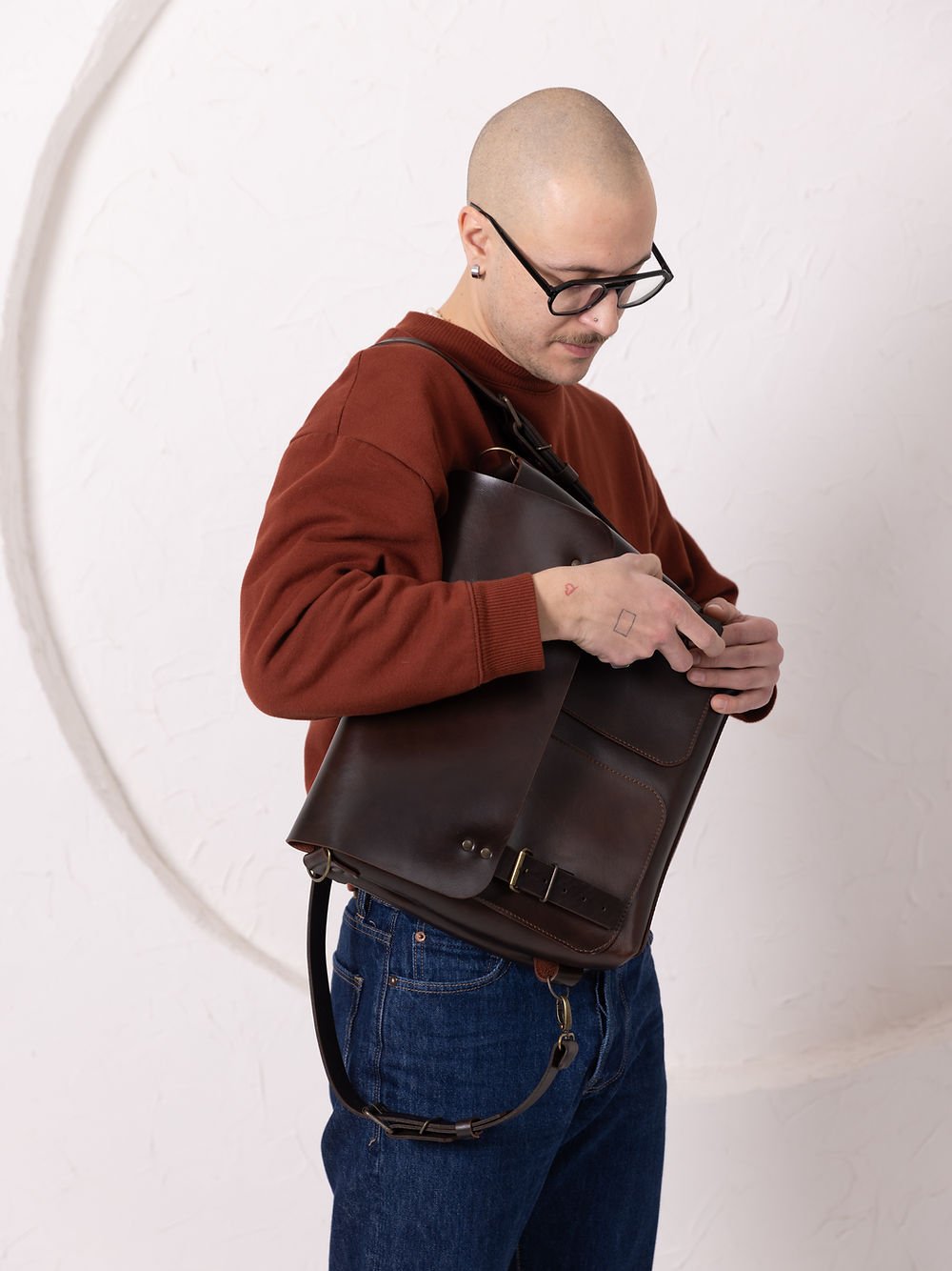 5. Male model wearing TOKS VISOKS BENJAMIN Backpack in dark chocolate leather, full body view from the back