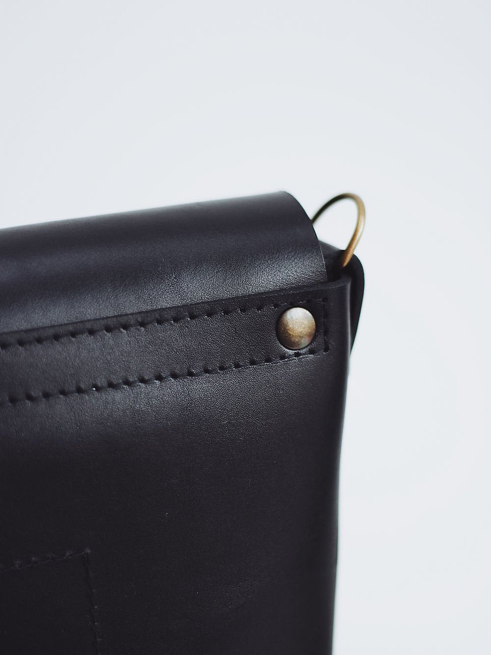 7. Close-up of side buckle detail on black leather BENJAMIN Backpack by TOKS VISOKS