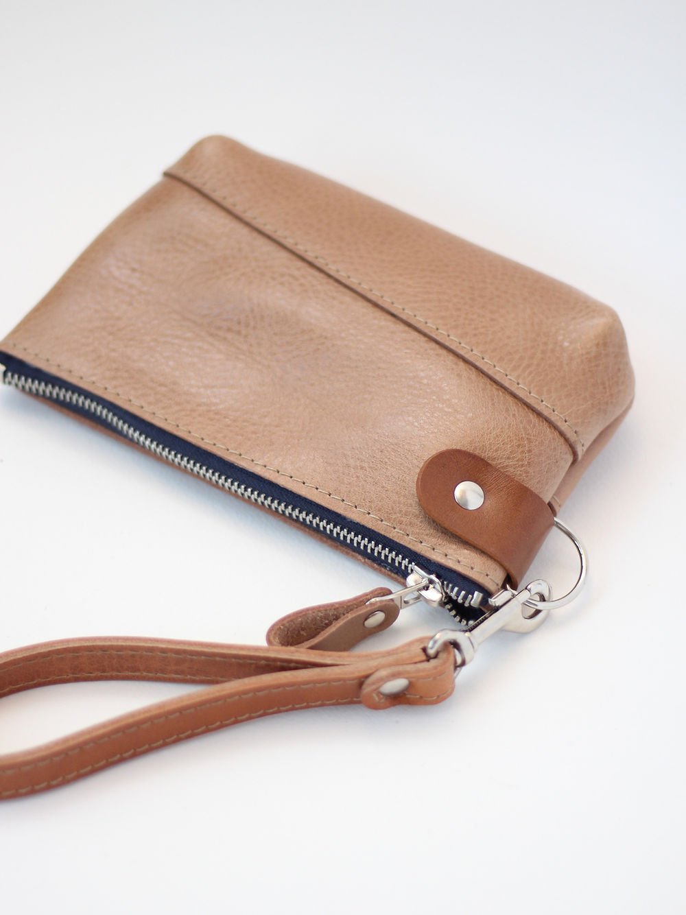 3. Studio shot of TOKS VISOKS brown leather POUCH Wallet with secure zipper and wrist strap