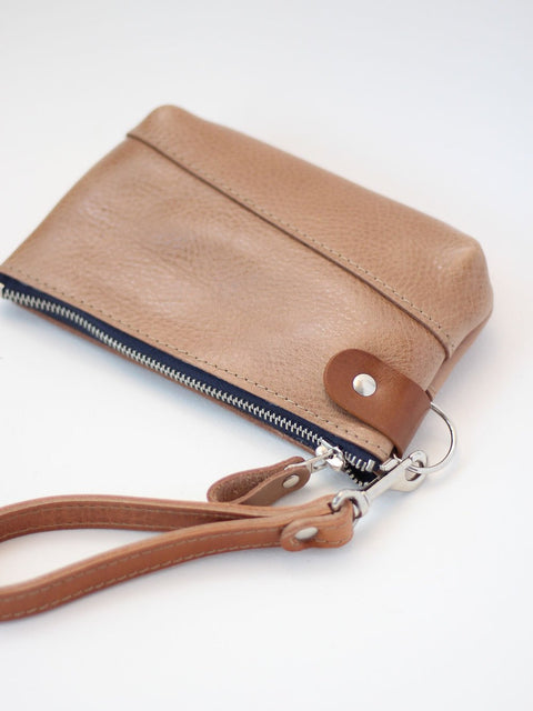 3. Studio shot of TOKS VISOKS brown leather POUCH Wallet with secure zipper and wrist strap