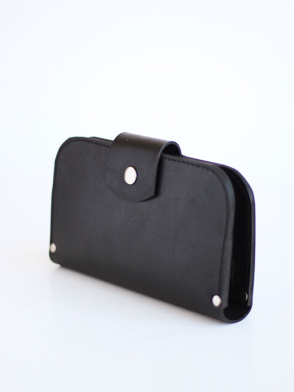 1. Black SATURDAY wallet by TOKS VISOKS in studio setting, showcasing sleek leather design with snap closure