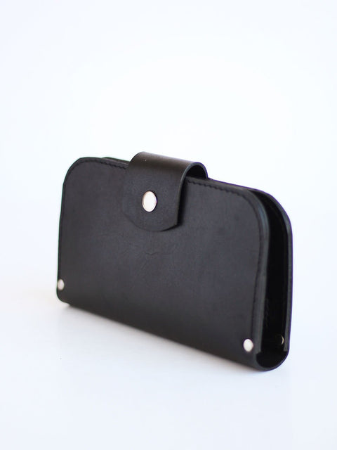 1. Black SATURDAY wallet by TOKS VISOKS in studio setting, showcasing sleek leather design with snap closure