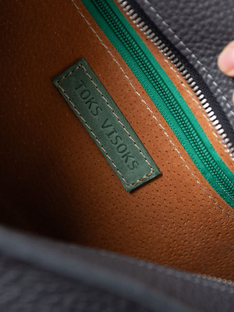 3. Interior view of TOKS VISOKS STELLA handbag, highlighting brand label and green zipper