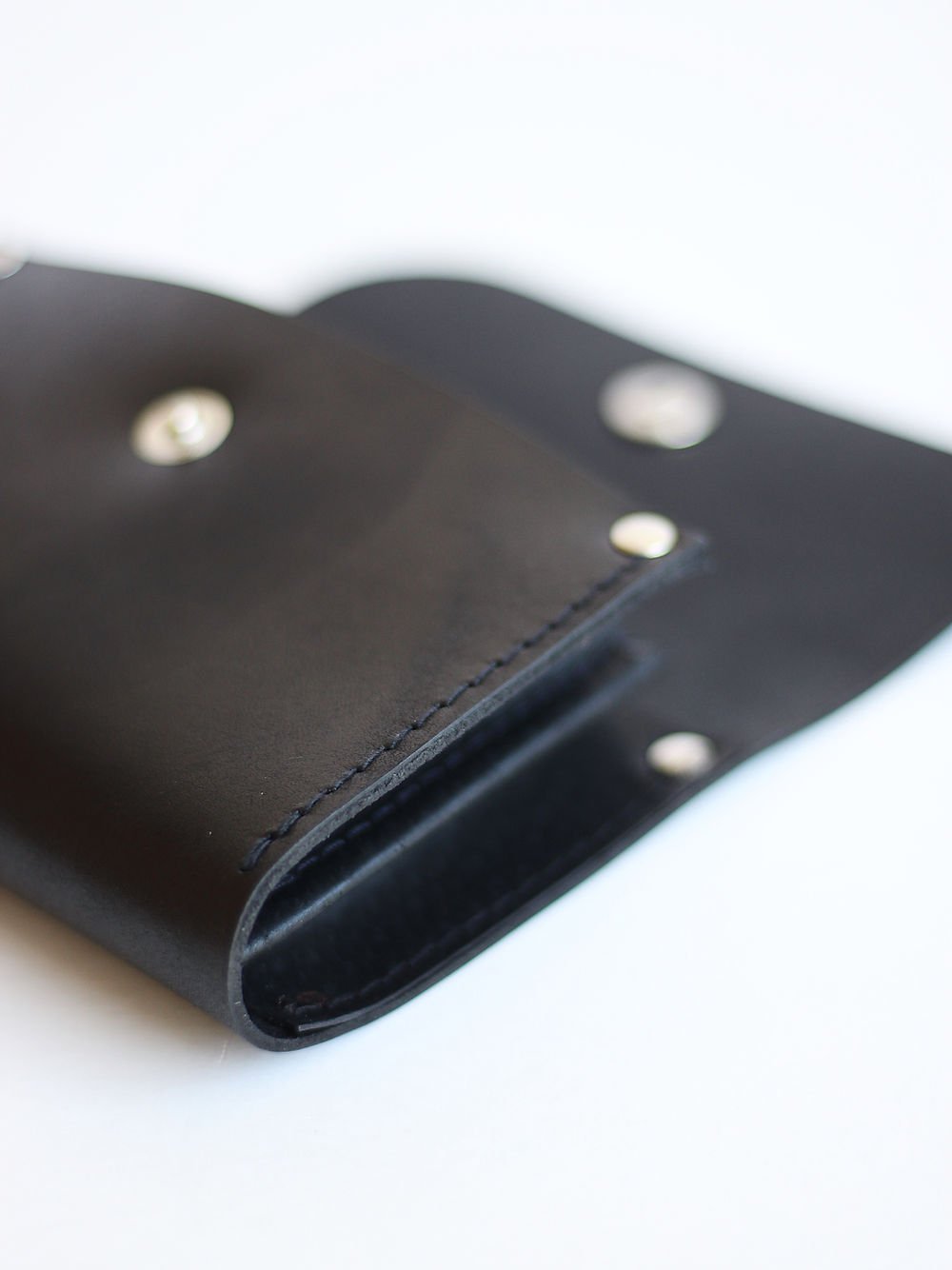 4. Close-up of black FRIDAY Wallet by TOKS VISOKS highlighting recycled leather material and stitching details
