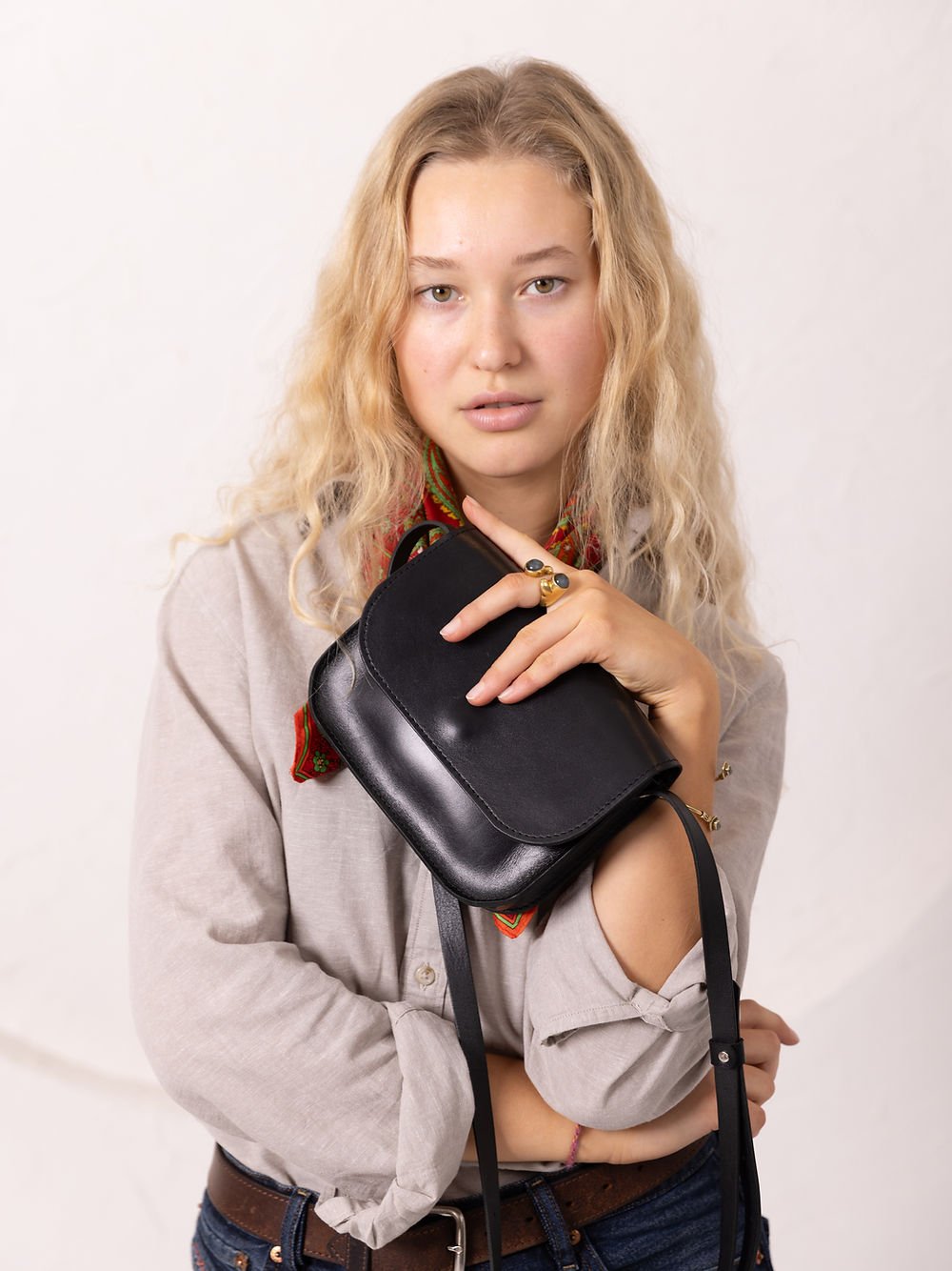 6. Women's black RUBY Purse by TOKS VISOKS held by model in studio setting