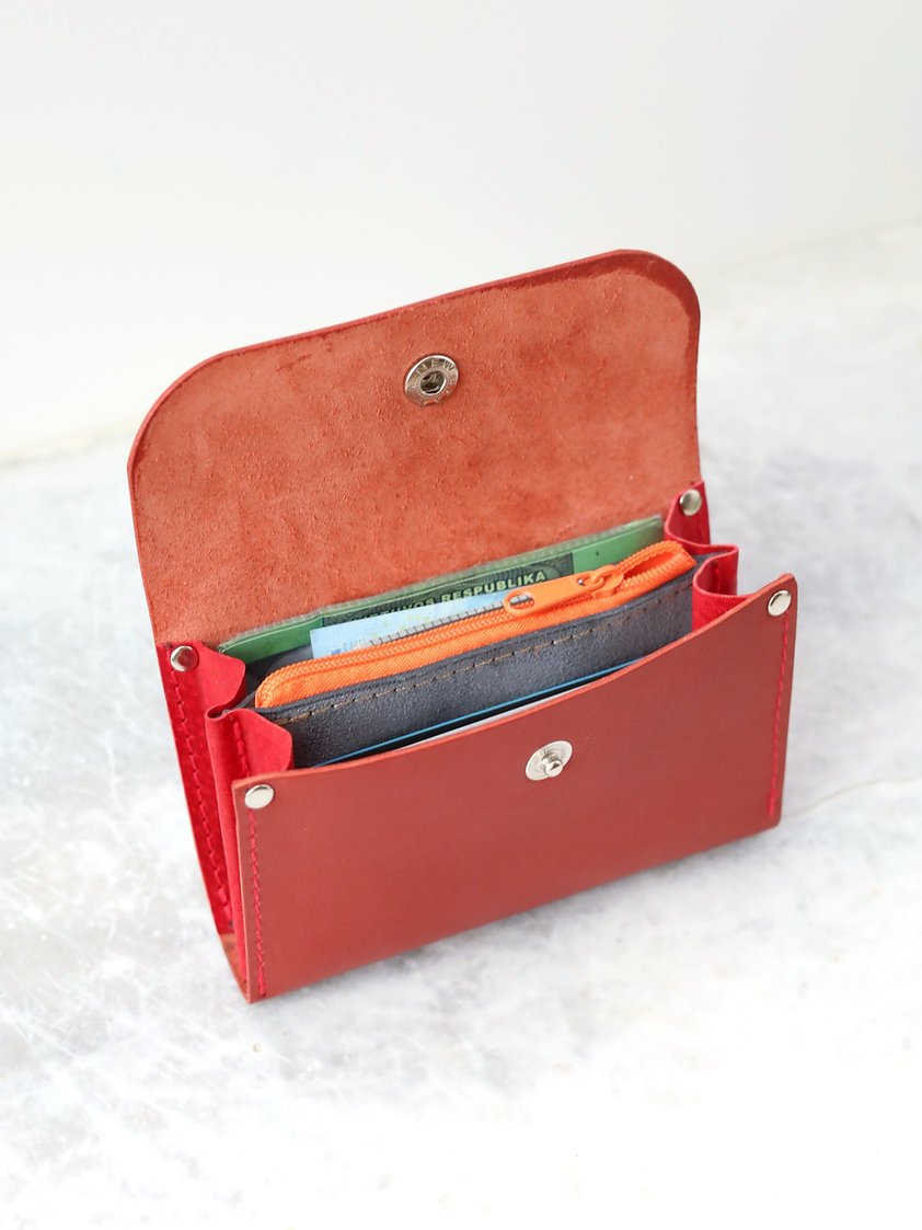 3. Open TOKS VISOKS FRIDAY Wallet in faded red, displaying organized compartments for cards and cash