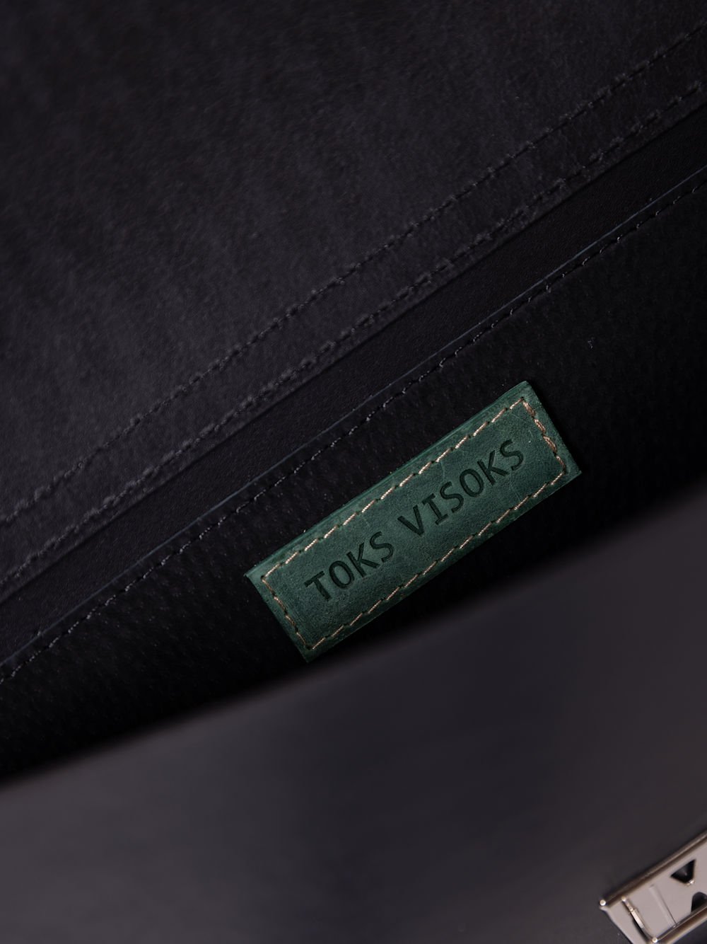 5. Interior view of TOKS VISOKS ASTORIA handbag showing brand label