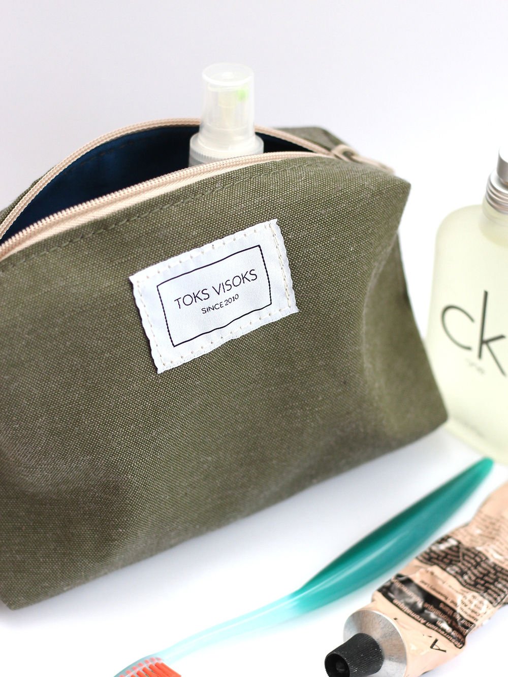2. TOKS VISOKS LORNA Makeup Bag in army green with toiletries, highlighting brand label