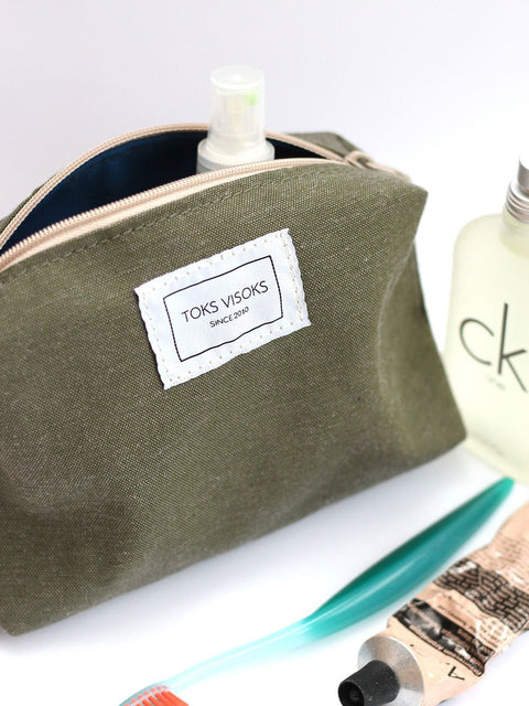 2. TOKS VISOKS LORNA Makeup Bag in army green with toiletries, highlighting brand label