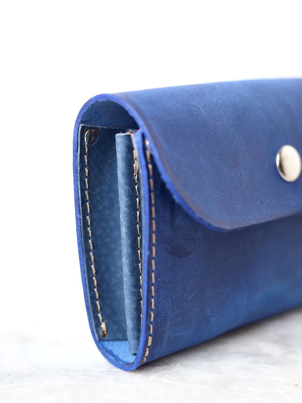 4. Close-up of blue TOKS VISOKS FRIDAY Wallet, showing side stitching and recycled leather texture