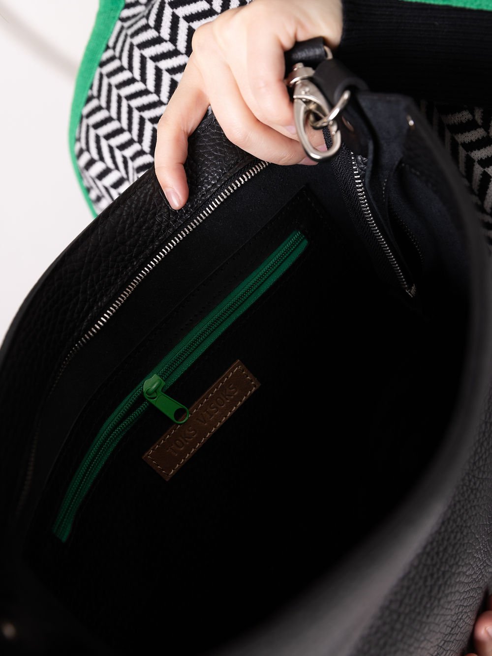 7. Close-up of ADDISON Leather Tote interior, featuring smooth sliding zipper and secret inner pocket