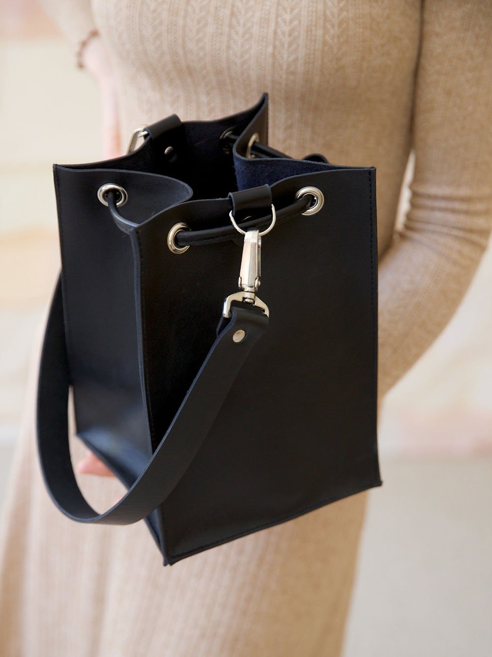 7. Close-up of black TOKS VISOKS PIPER Purse, highlighting strap and secure closure, studio setting