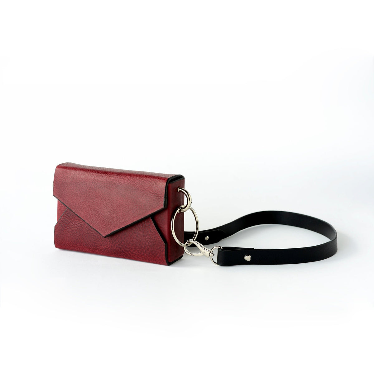 10. Side view of Daz Studio burgundy leather envelope bag with adjustable strap and silver magnet closure