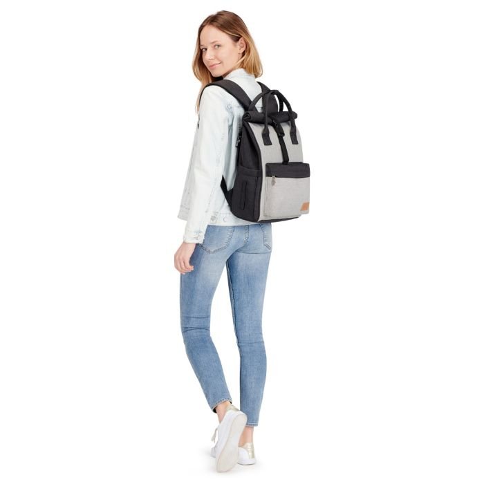 8. Woman wearing Kinderkraft Moonpack diaper backpack in grey and black, standing in casual outfit