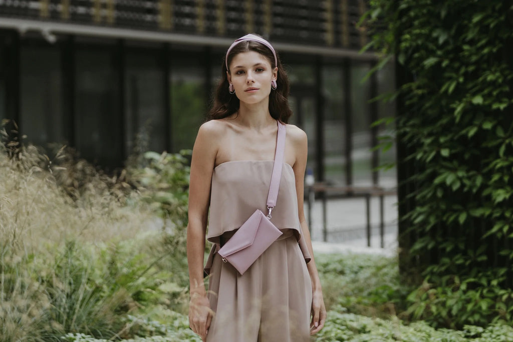 2. Women's pink Gerda Retter shoulder bag styled with beige outfit in garden setting