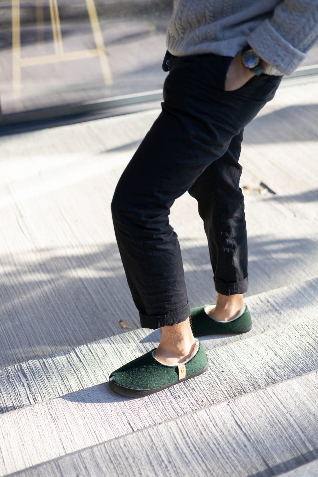 2. Unisex dark green TOKU Budapest slippers with lambswool lining, worn by male model outdoors