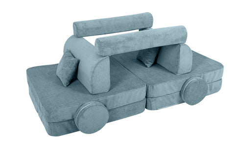 2. Turquoise corduroy children's sofa arranged in a creative structure with cylindrical and square cushions on a black background