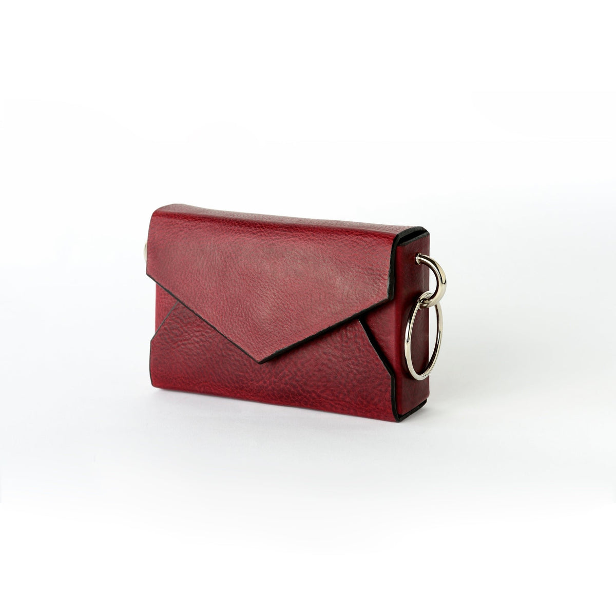6. Close-up of Daz Studio burgundy leather envelope bag highlighting embossed logo and silver magnet closure