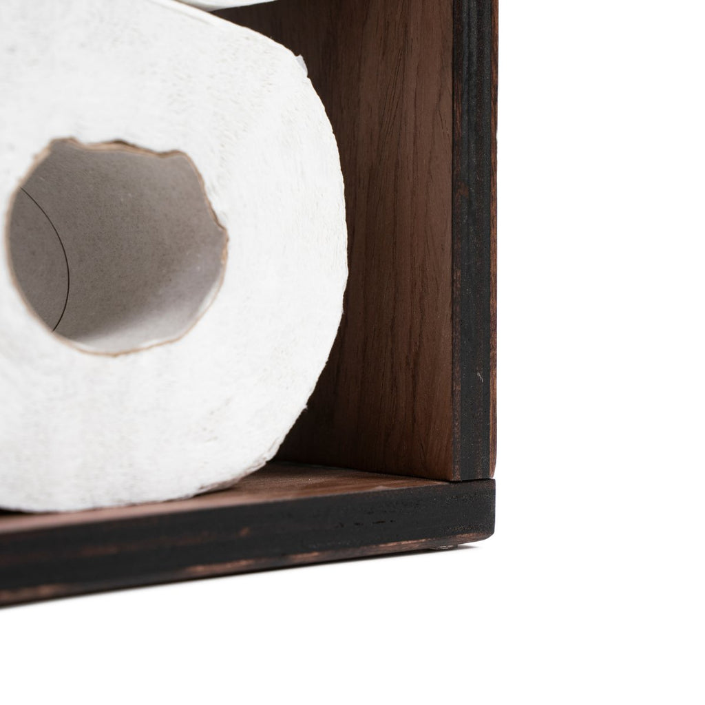 2. Close-up of toilet paper roll inside wooden holder, highlighting birch plywood texture