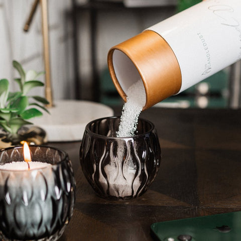 3. Candledust Breeze powdered candle being poured into a decorative glass container, highlighting creative use