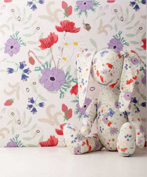 1. Vanilla Meadow eco wallpaper with floral and butterfly pattern in a room setting with a stuffed rabbit toy