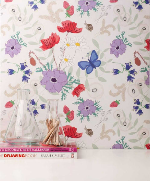 1. Vanilla Meadow eco wallpaper with floral and butterfly pattern in a room setting with glass jars and books
