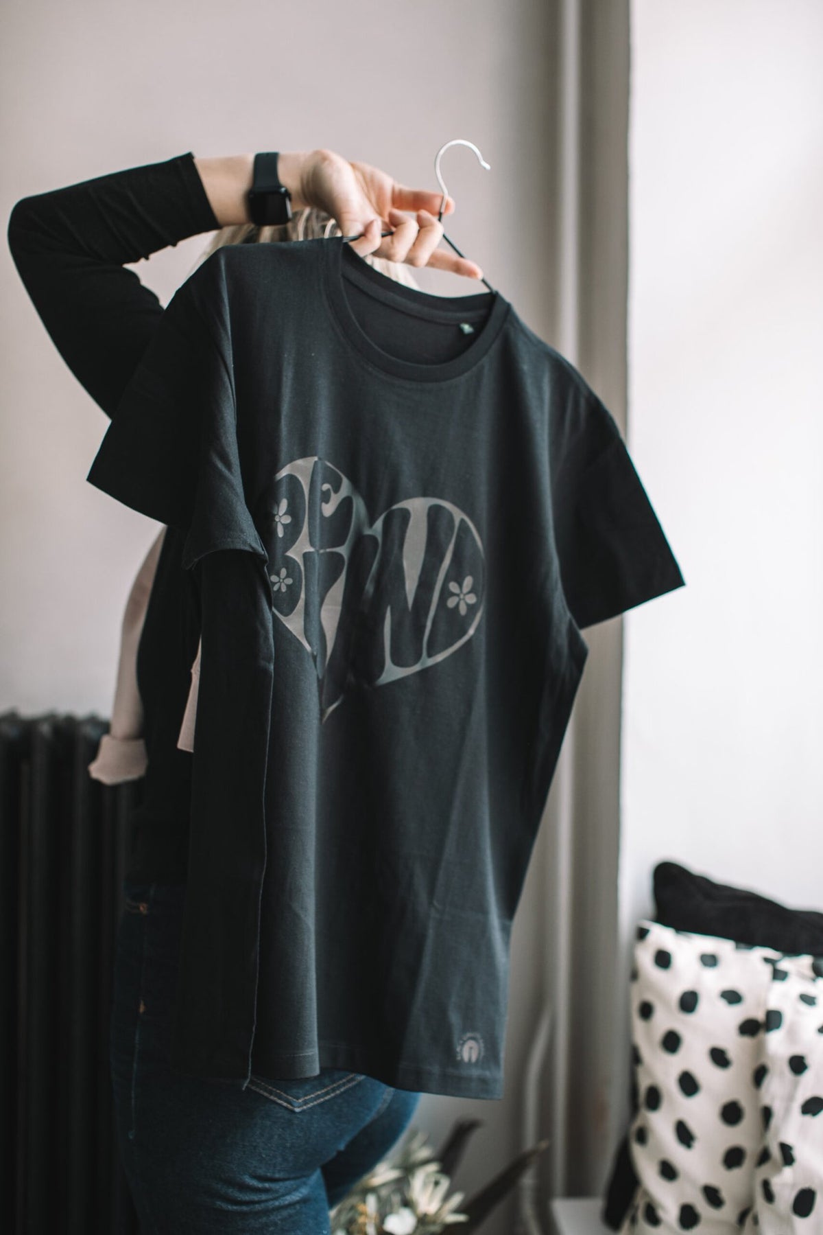 4. Black Giraffe Brand Be Kind T-shirt on hanger, showing black-on-black print and organic cotton material