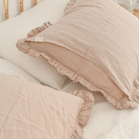 1. Pair of beige linen pillowcases with frills on a white bed, creating a cozy bedroom setting