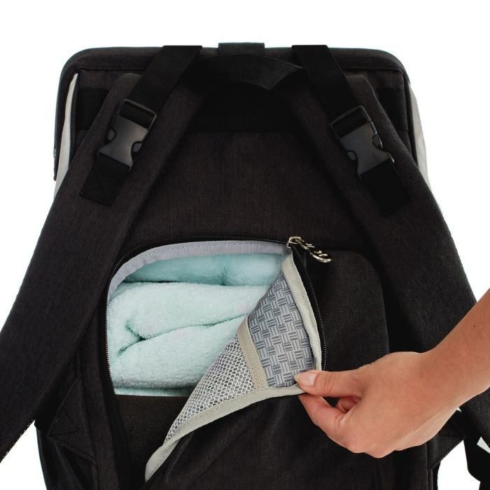 3. Close-up of Kinderkraft Molly backpack's back pocket with hand accessing interior storage