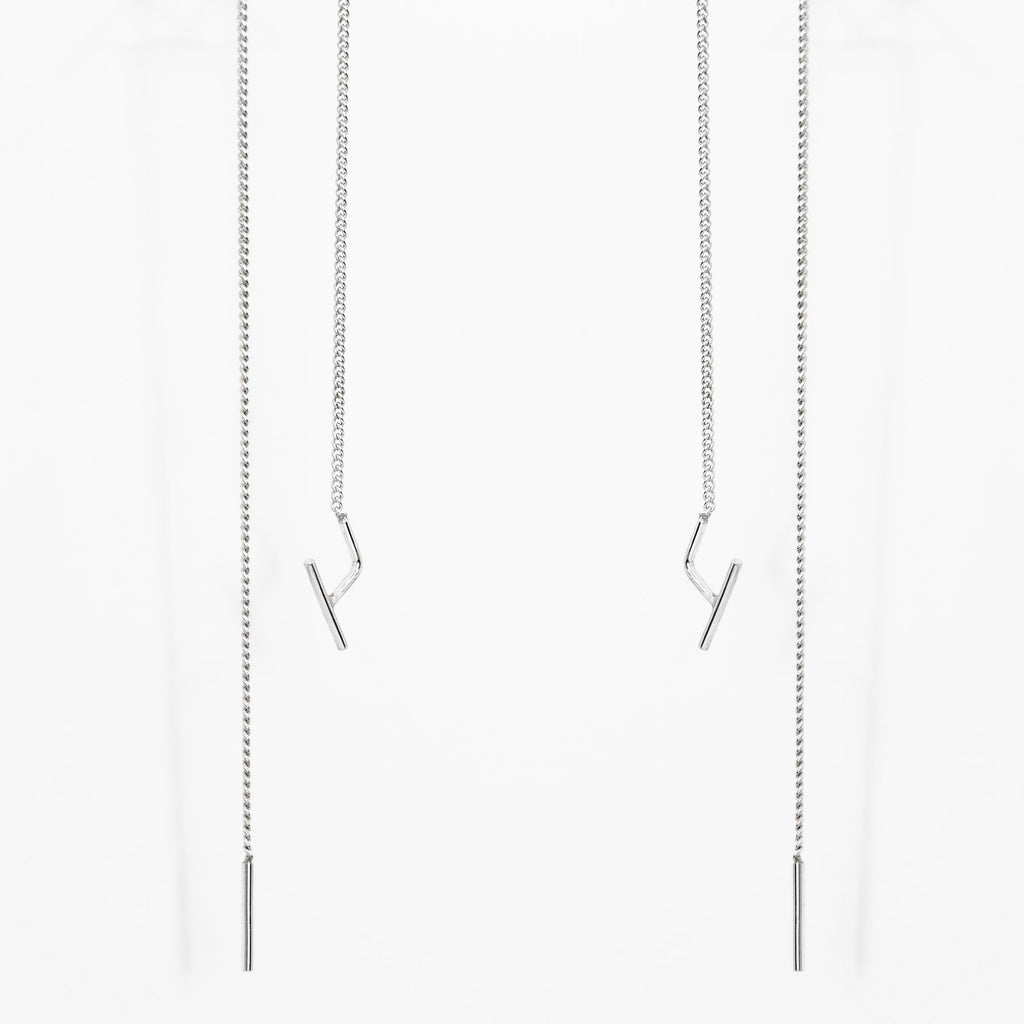 2. Studio image of Maarja Palu SWING earrings with long silver chains and minimalist design
