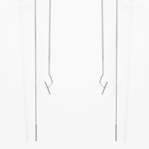 2. Studio image of Maarja Palu SWING earrings with long silver chains and minimalist design