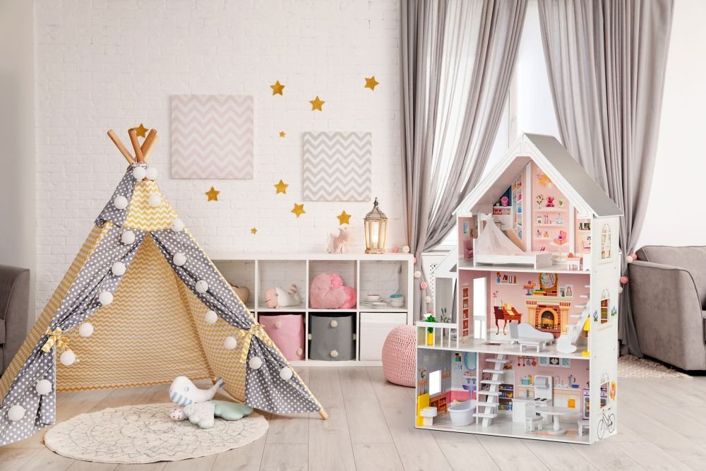 1. Gerardo's Toys wooden dollhouse with LED lights in a playroom with a teepee tent and star decorations