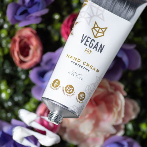 4. Hand holding Vegan Fox Protective Hand Cream, 120 ml, in a minimalistic setting