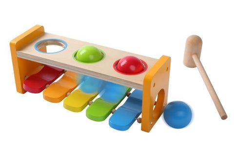 2. Side view of Gerardo's Toys 2in1 musical hammer bench with colorful balls and xylophone, featuring wooden hammer and blue ball, emphasizing interactive play and color recognition