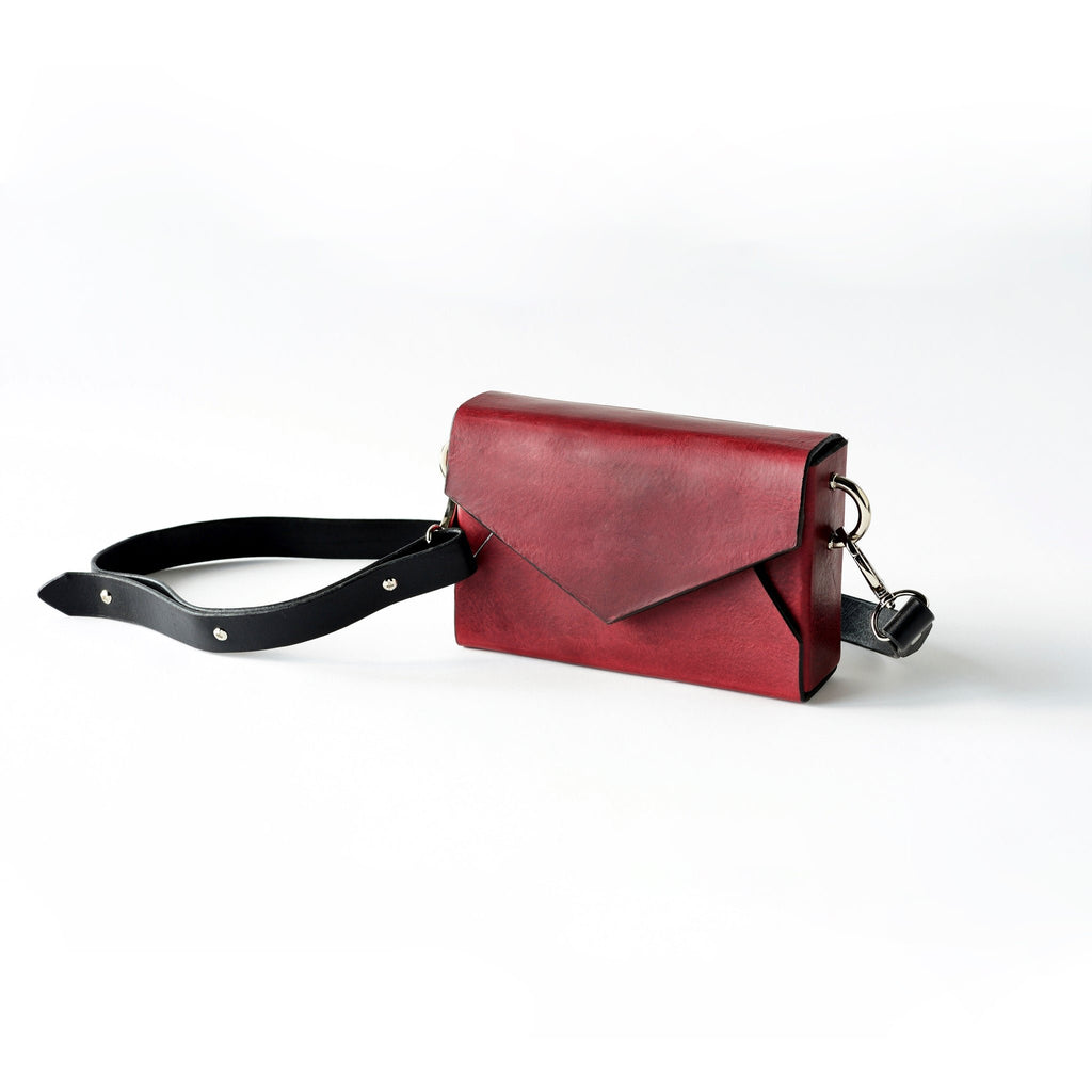 7. Daz Studio burgundy leather envelope bag with protective dust bag and embossed logo tag