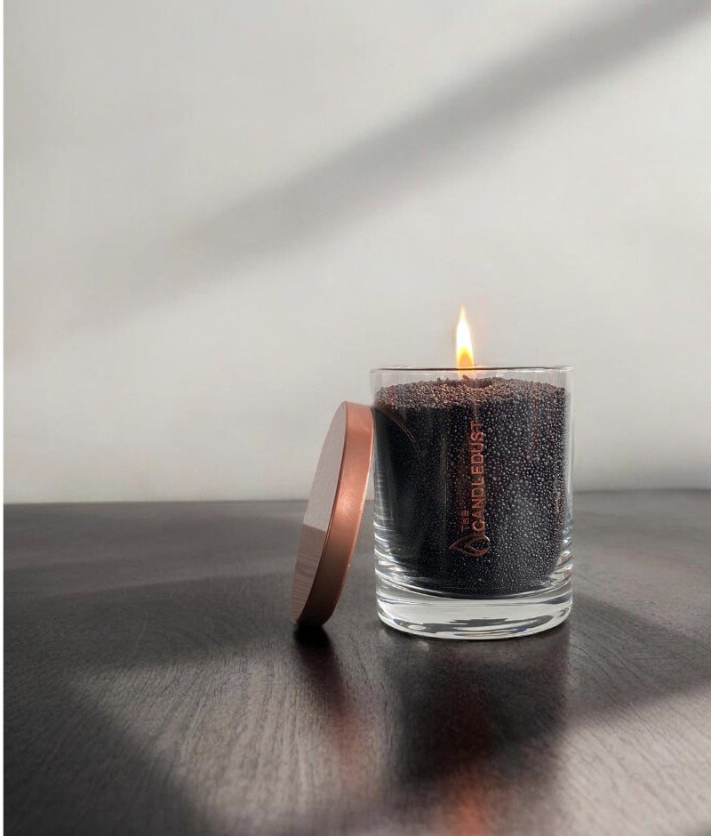 3. Black unscented powder candle by Candledust with flame and lid beside, in glass container