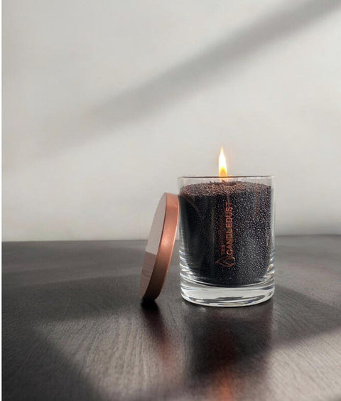 3. Black unscented powder candle by Candledust with flame and lid beside, in glass container