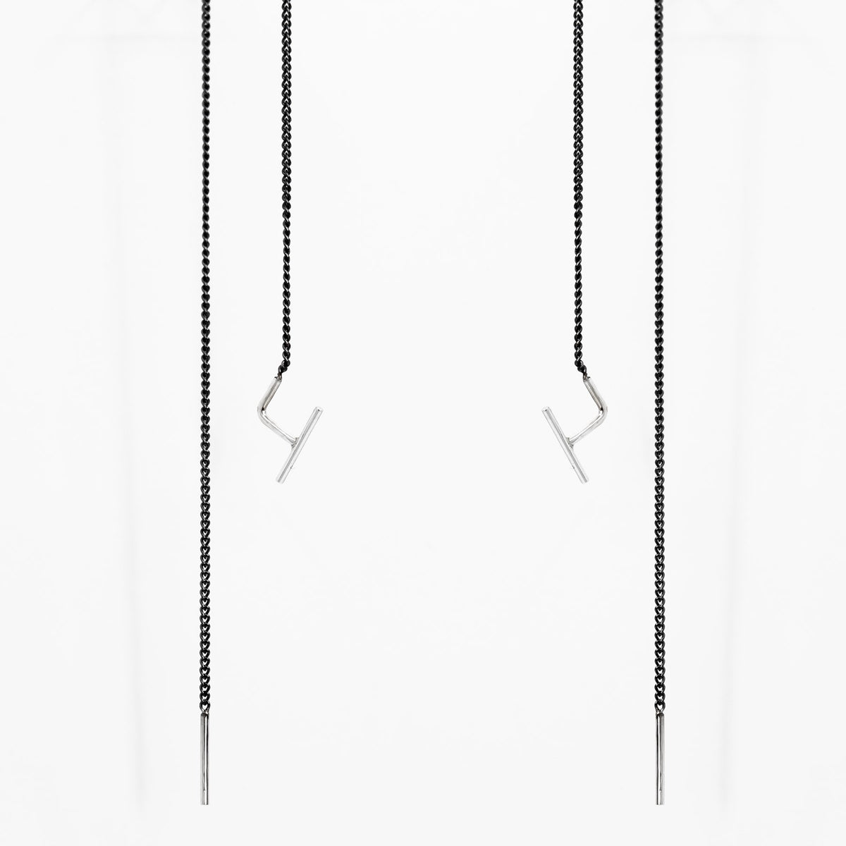2. Studio image of Maarja Palu SWING 2 earrings with minimalist bar accents and oxidized silver chains