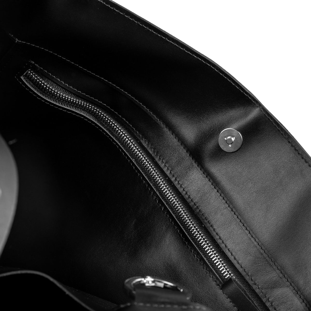 9. Close-up of PYKOK Adele handbag interior, highlighting zipper pocket and magnetic closure