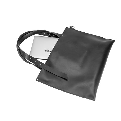 5. Flat lay of PYKOK Adele large handbag in black leather, showing interior with laptop