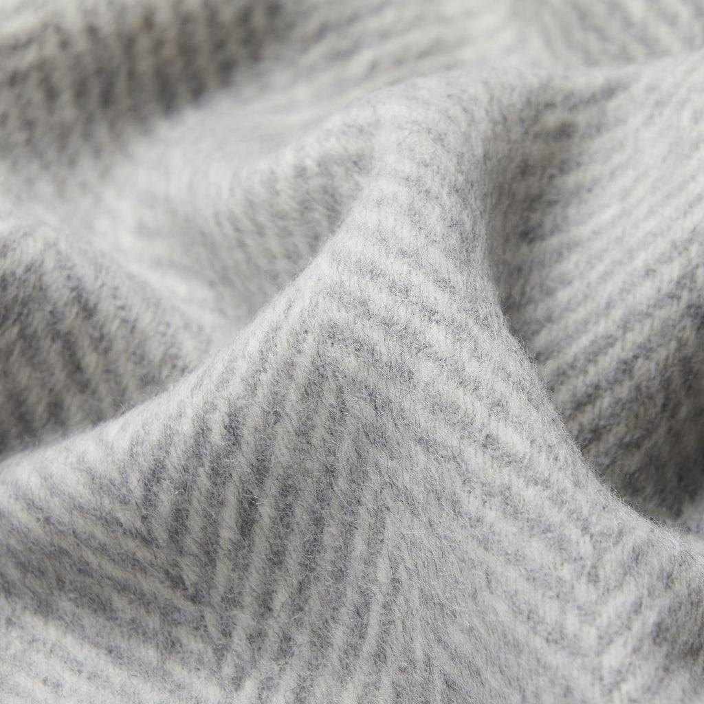 6. Close-up of light gray Alpaka wool throw highlighting fishbone texture