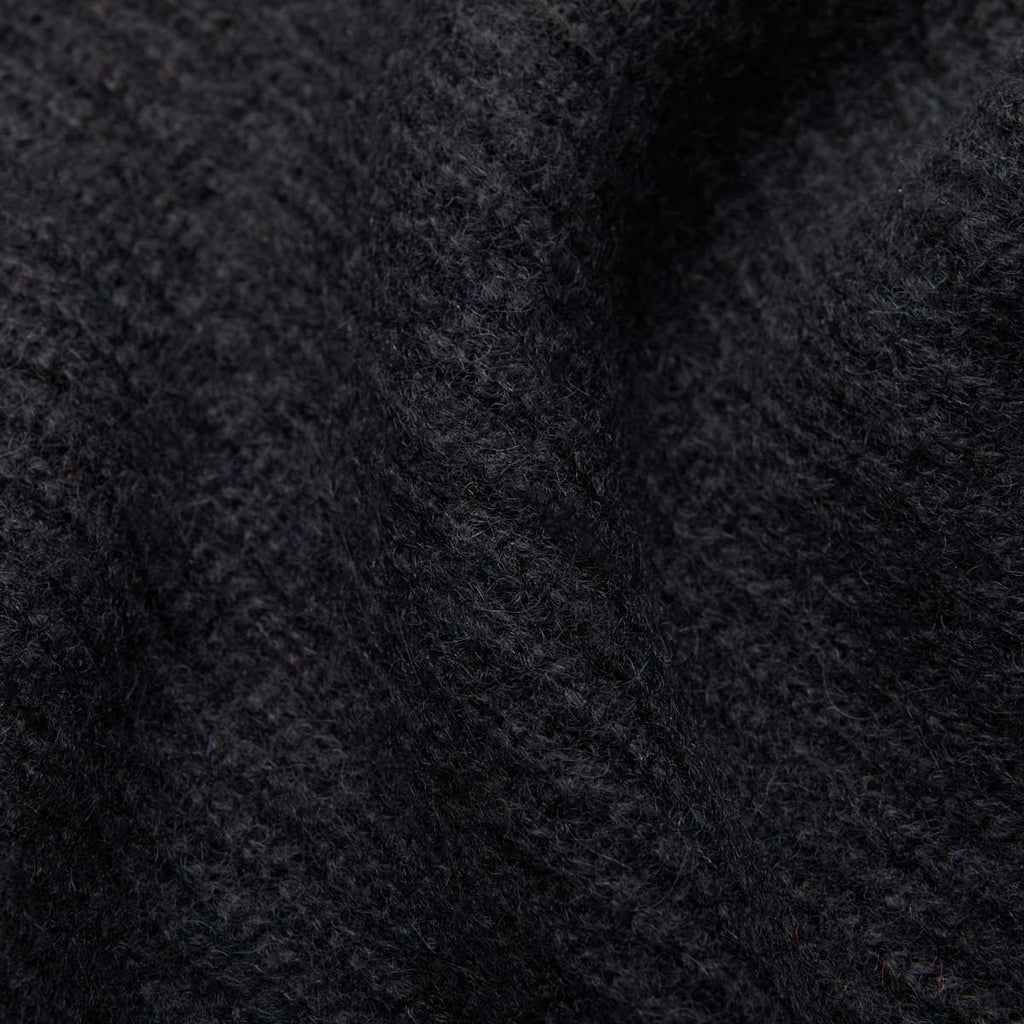7. Close-up of black Alpaka Fisherman's Rib scarf highlighting ribbed texture