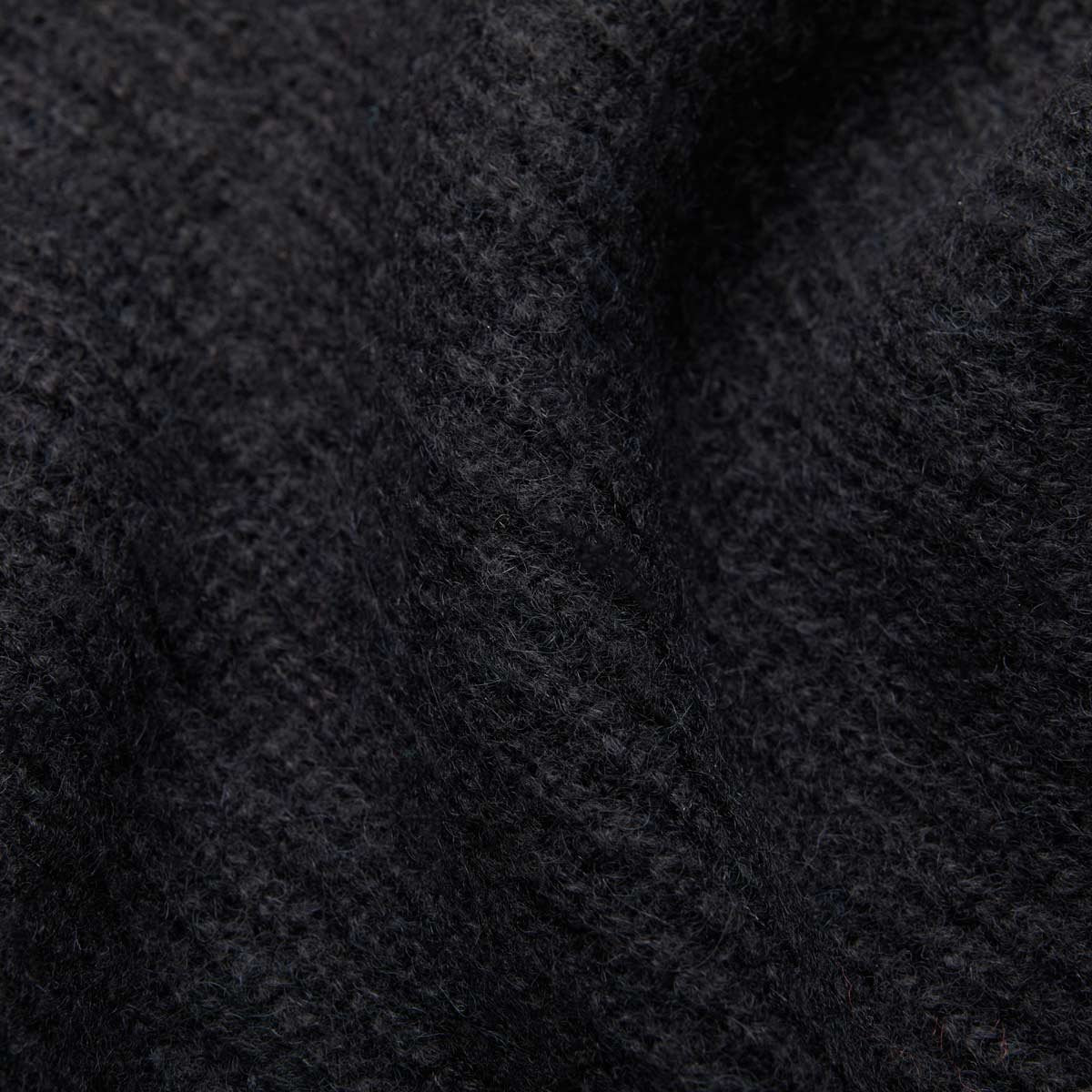 7. Close-up of black Alpaka Fisherman's Rib scarf highlighting ribbed texture