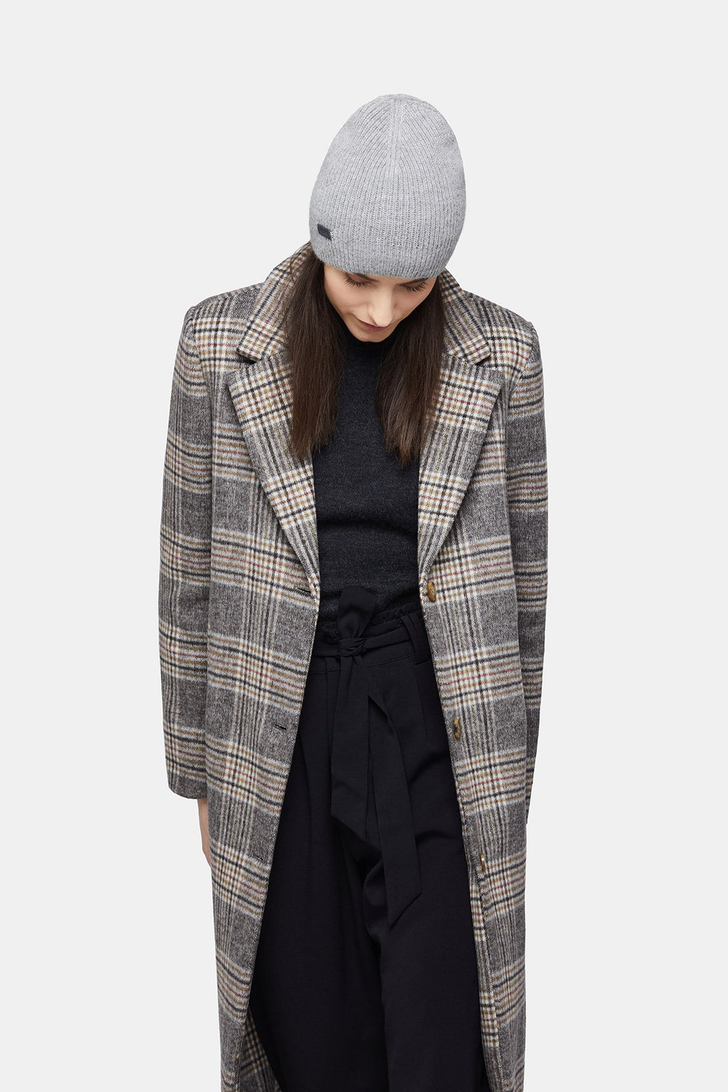 4. Woman wearing silver Alpaka baby alpaca wool fisherman's rib beanie with plaid coat, looking down