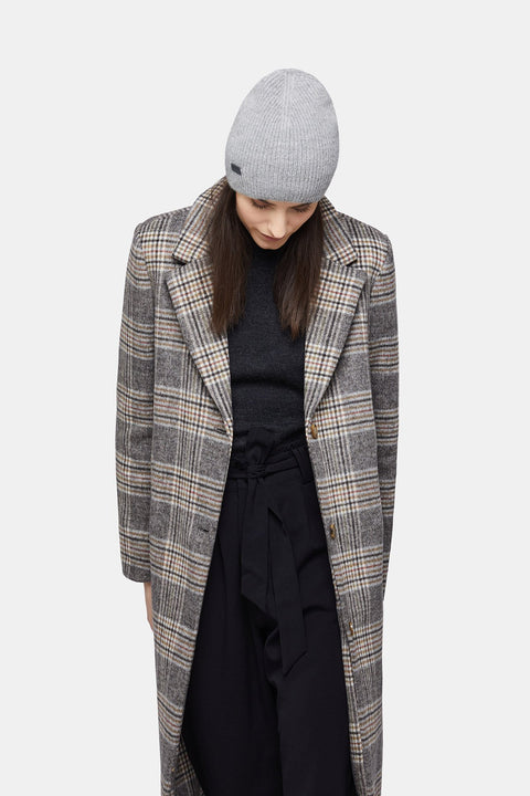 4. Woman wearing silver Alpaka baby alpaca wool fisherman's rib beanie with plaid coat, looking down