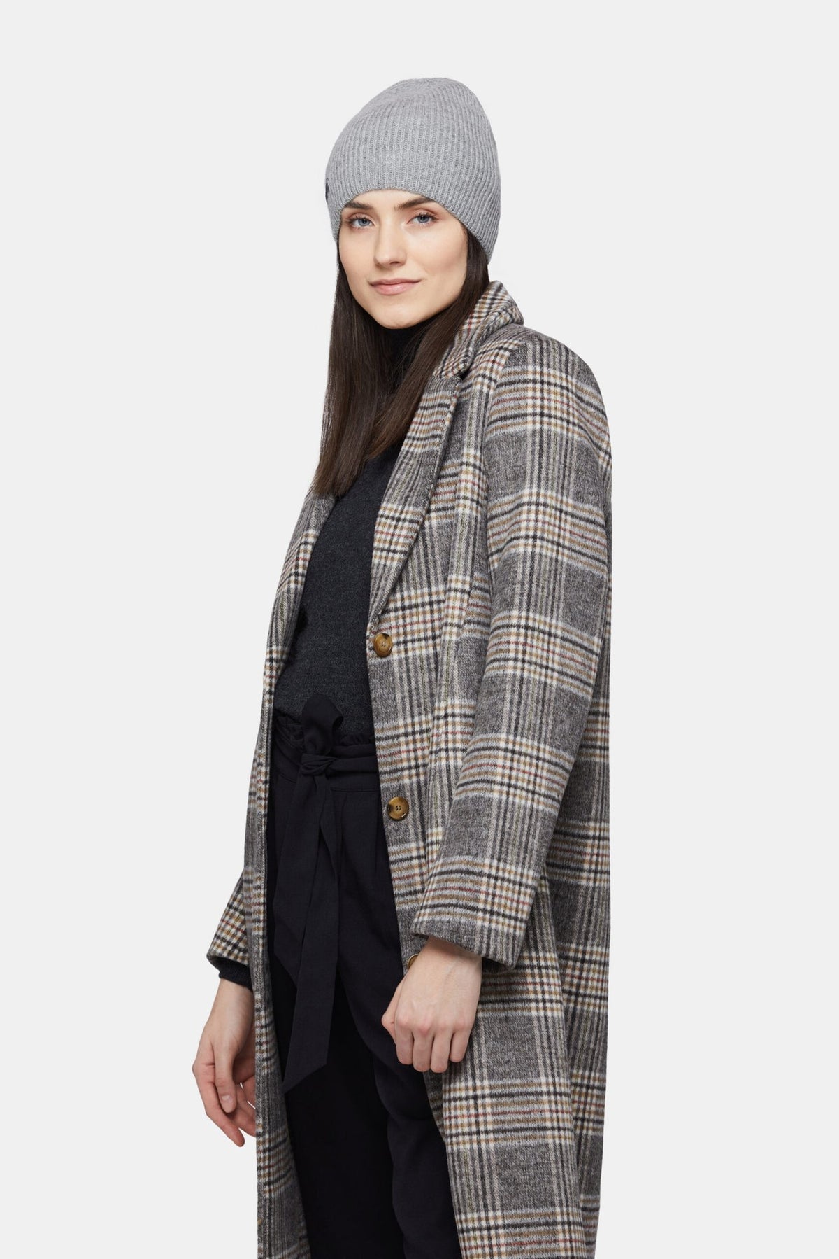 6. Woman wearing silver Alpaka baby alpaca wool fisherman's rib beanie with plaid coat, shown in side view